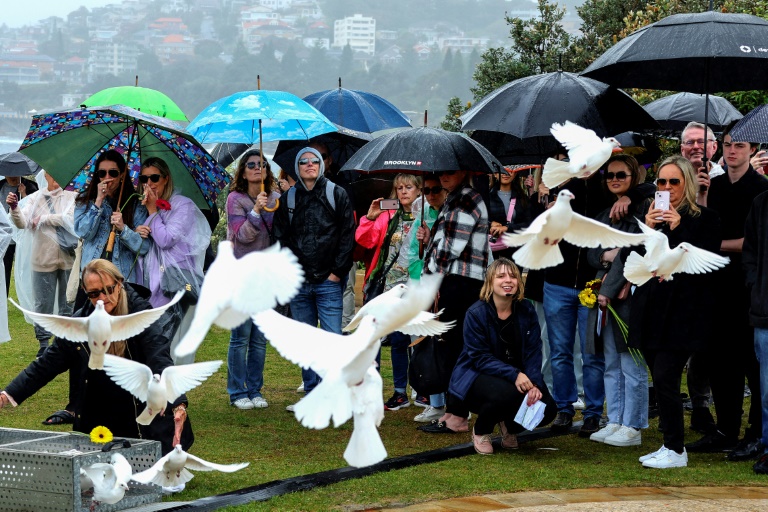 Eliberarea porumbeilor în timpul comemorării a 20 de ani de la bombardamentele de la Bali, pe 12 octombrie 2022, la Coogee Beach, Sydney, Australia (AFP - DAVID GRAY)